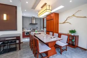 a kitchen with a table and chairs in a room at Book and Bed-ChongMing in Shanghai