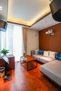 a living room with a couch and a table at Book and Bed-ChongMing in Shanghai