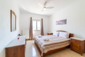 a bedroom with a large bed and a window at Pounda Breeze in Pounda