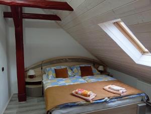 a bedroom with a bed with towels on it at Apartmán Eva in Vrbov