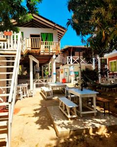 a patio with tables and chairs in front of a building at Cabañas Isla Bonita in Puerto Limón