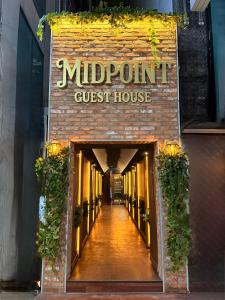 a brick building with a sign that reads midtown guest house at Midpoint Guesthouse in Busan