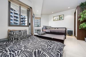 a bedroom with a bed and a window at Studio for 5 at Tambuli Residences Garden View by Dominik Studio Apartment with Pool Access & Balcony in Mactan in Maribago +52 photos