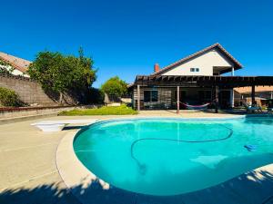 an empty swimming pool in front of a house at Joshie home in Rancho Cucamonga +43 photos