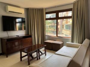 a living room with a couch and a tv and a table at One bedroom at Crosswinds in Ulot