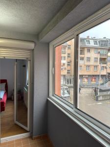 a room with two windows and a view of a street at alisa in Srebrenik