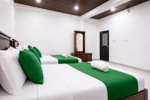 two beds in a room with green and white at Enara Luxury Stay in Katugastota +50 photos
