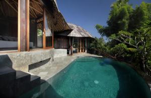 a swimming pool in front of a villa at Babakan Hill Villas in Jasri