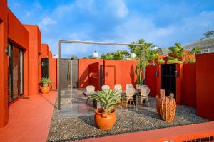 a patio with chairs and tables on a building at Afro Pool Villa Bangsean 01 in Ban Puk (2)