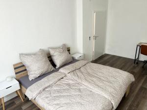 a bedroom with a bed with pillows on it at Green Loft - Haus der Natur in Spiesen-Elversberg +3 photos