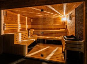 a large wooden sauna with a tub in a room at Hotel Break Hradec Králové in Hradec Králové