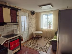 a small kitchen with a table and a window at Mäe Apartment in Tartu +1 photo