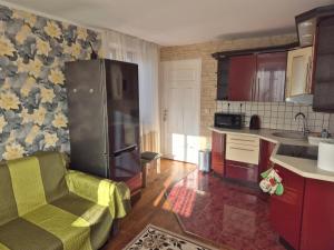 a kitchen with a stainless steel refrigerator in a room at Mäe Apartment in Tartu