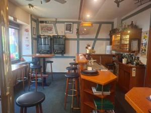 a bar in a restaurant with stools and tables at Weingasthaus zum Fährhof in Winningen