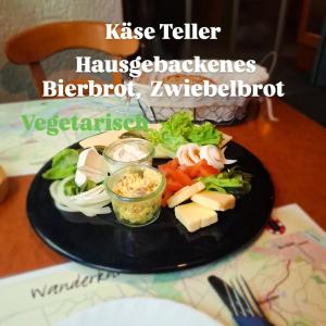 a plate of food with vegetables on a table at Weingasthaus zum Fährhof in Winningen +1 photo