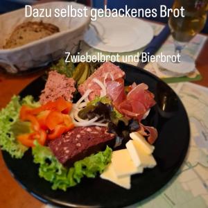 a plate of food with meat and vegetables on a table at Weingasthaus zum Fährhof in Winningen