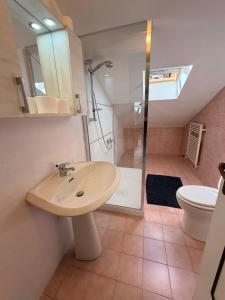 a bathroom with a sink and a shower at Appartamento il Punto Alto in Baveno +8 photos