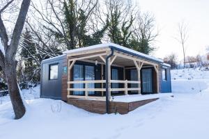 a cabin with a blue roof in the snow at Luxury Home in Igal +6 photos