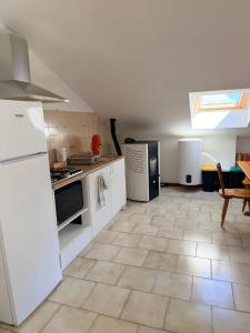 a kitchen with white appliances and a tile floor at Appartamento il Punto Alto in Baveno