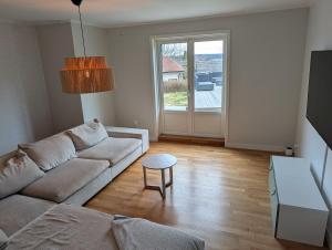 a living room with a couch and a table at Exclusive villa with a stunning view in Sigtuna