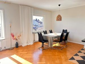 a dining room with a table and black chairs at Exclusive villa with a stunning view in Sigtuna