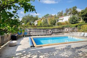 a swimming pool in the backyard of a house at Exclusive villa with a stunning view in Sigtuna