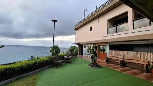 a house with a patio with a view of the ocean at Marjhun's Apartelle in Jagna