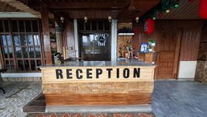 a bar with a sign that reads reception at Marjhun's Apartelle in Jagna