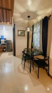 a dining room with a glass table and chairs at Marjhun's Apartelle in Jagna