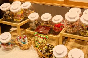 a group of jars of candy on a table at Hana Beppu in Beppu