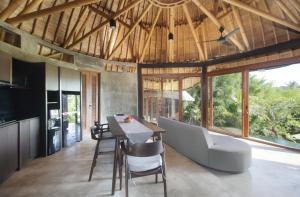 a kitchen and dining room with a table and chairs at Babakan Hill Villas in Jasri