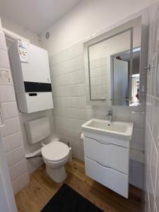 a white bathroom with a toilet and a sink at Haakestrasse 1j in Dahme +16 photos