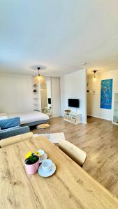 a living room with a wooden table and a couch at Studio apartment in Pärnu