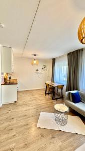 a living room with a couch and a table at Studio apartment in Pärnu