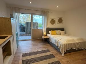 a bedroom with a bed and a large window at Deich Quartier 9.2 in Dorum-Neufeld