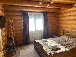 a bedroom with a bed in a log cabin at Смерековий двір in Polyana +92 photos