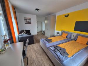 a bedroom with a large bed with a yellow wall at Casa Novis in Băicoi