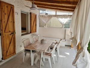 a dining room with a wooden table and chairs at Casa Bruna in San Teodoro