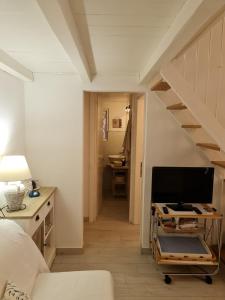 a living room with a staircase with a television at Casa Bruna in San Teodoro