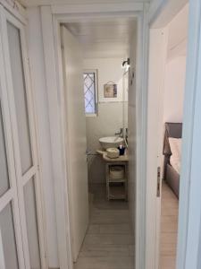 a small bathroom with a sink and a mirror at Casa Bruna in San Teodoro +63 photos