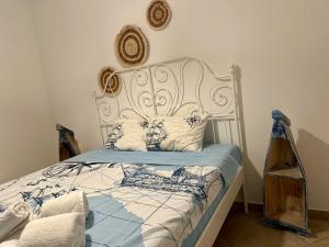 a bedroom with a bed with a white headboard at Mare Monte Suites 2 in Parasporos