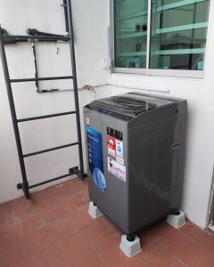 a heater sitting on a tile floor next to a window at Cem Miri Homestay 2 in Miri