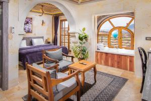 a bedroom with a bed and a table and chairs at Moonstone in Cappadocia in Uçhisar