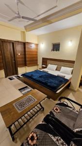 a bedroom with two beds and a table at Hotel Jai Palace in Pachmarhī +9 photos