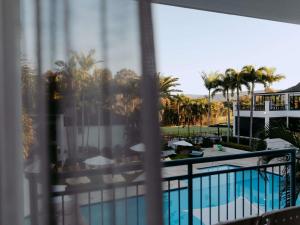 a view of a pool from a hotel balcony at Mercure Gold Coast Resort in Gold Coast