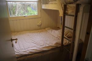 a bedroom with a bunk bed and a window at Holiday Home in Thyholm