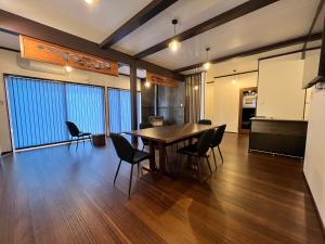 a dining room with a table and chairs at 季紀の杜阿蘇 in Aso