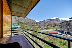 a balcony with a view of the mountains at Royal Ocean COTTAGE in Manāli