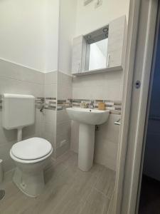 a bathroom with a white toilet and a sink at b&b Vitae in Tremensuoli +1 photo