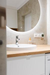 a bathroom with a sink and a mirror at Apartament Harmonia Baltic in Sarbinowo +18 photos